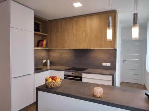 a kitchen with a bowl of fruit on a counter at Apartmán Pod zámkem in Mikulov