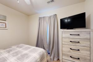 a bedroom with a bed and a dresser with a flat screen tv at Tanner's Retreat in Branson