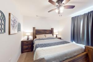 a bedroom with a bed and a ceiling fan at Tanner's Retreat in Branson
