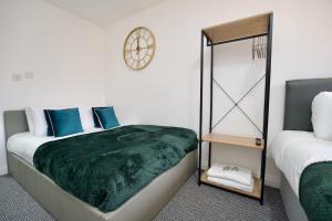 a bedroom with two beds and a mirror at Swan Studio Three - Coventry in Coventry