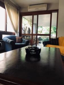 a living room with a table and a couch at Apto Bonfim Redenção 2 carros e sacada vip in Porto Alegre