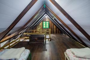 a room with two beds in a attic at Casa do Tesouro in Joinville