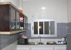 a kitchen with a sink and a cabinet at sembene tourisme ngaparou in Ngaparou