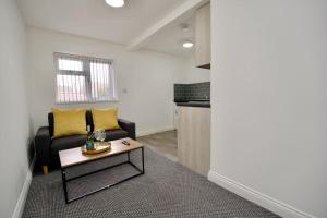 a living room with a couch and a table at Swan Studio Five - Coventry in Coventry