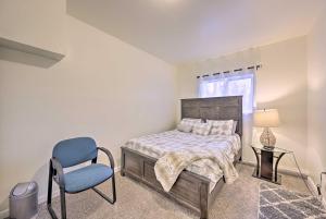 a bedroom with a bed and a chair and a window at Modern Home with Deck about 14 Mi to Downtown Seattle! in Shoreline