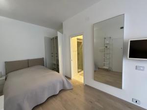 1 dormitorio con cama y espejo grande en Monolocale, en Roma