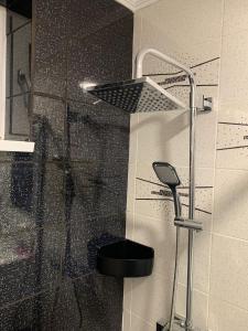 a shower in a bathroom with a glass shower at Central Apartament in Bîrlad