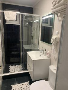 a bathroom with a shower and a sink and a toilet at Central Apartament in Bîrlad