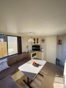 a living room with a couch and a table at Cosy mobile house in the heart of Goricko in Moravske Toplice