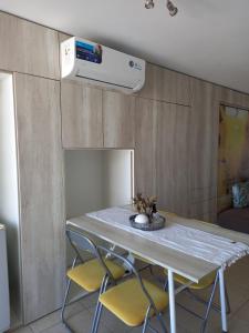 a kitchen with a table with two chairs and a stove at 11 De Septiembre 3255 in Mar del Plata