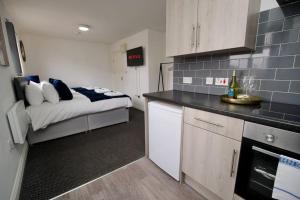 a small kitchen with a bed in a room at Swan Studio Eight - Coventry in Coventry