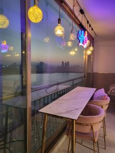 a table and chairs on a balcony with a view at Hangang River view Apartment in Seoul