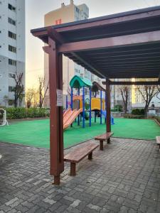 a park with a bench and a playground at Hangang River view Apartment in Seoul
