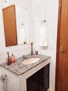 a bathroom with a sink and a mirror at Lumiar - Casa do Sol in Nova Friburgo
