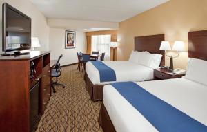 a hotel room with two beds and a flat screen tv at Holiday Inn Express Scottsdale North, an IHG Hotel in Scottsdale