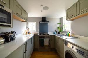 a kitchen with white counters and a stove top oven at Beautiful one bed apartment in Bath