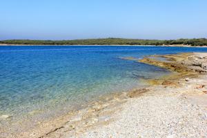 a large body of water with a rocky shore at Family friendly house with a swimming pool Kranjcici, Central Istria - Sredisnja Istra - 20585 in Svetvinčenat