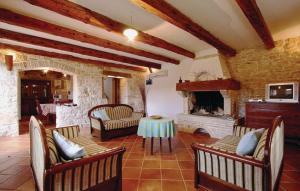 a living room with a fireplace and a table and chairs at Family friendly house with a swimming pool Kranjcici, Central Istria - Sredisnja Istra - 20585 in Svetvinčenat