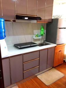 a kitchen with a sink and a counter top at Megatower Residences 3(8F-34) in Baguio