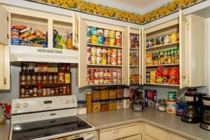 a kitchen filled with lots of food and drinks at Modern Bed & Breakfast In Abbotsford - Choose your Room Upstairs - S-1 - S-2 - S-3 in Abbotsford