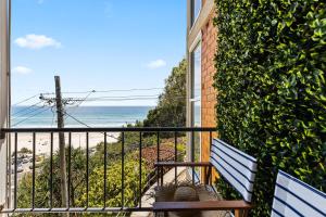 a balcony with a bench looking out at the ocean at Kirra Views in Gold Coast
