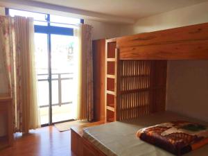 a bedroom with a bunk bed and a large window at Megatower Residences 3(8F-34) in Baguio