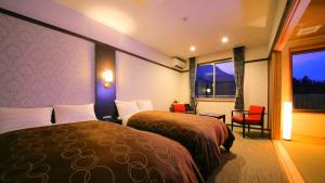 Cama ou camas em um quarto em Kuju Kankou Hotel