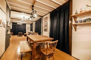 a dining room with a wooden table and chairs at Dragon House Misakicho - Vacation STAY 86282v in Ishigaki Island