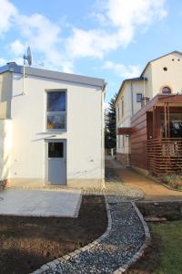 ein Haus mit einem Gehweg neben einem Gebäude in der Unterkunft Ferienwohnung Radebeul Gerlach in Radebeul