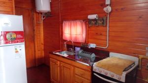 a small kitchen with a sink and a refrigerator at La Beatriz in San José