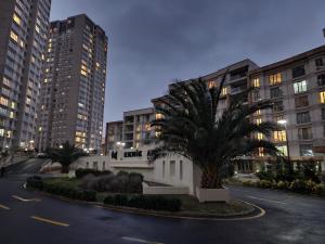 a palm tree in front of a building with tall buildings at Luxury apartment in Istanbul in Istanbul