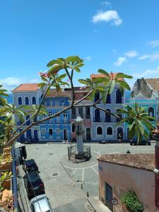 a view of a building with palm trees in front at Casa Almeida in Salvador