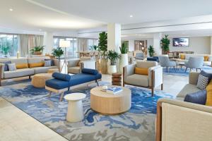 a lobby with couches and chairs and a table at Le Meridien Lav Split in Podstrana