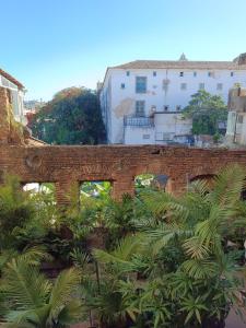 an old brick bridge with trees and buildings at Casa Almeida in Salvador +32 photos