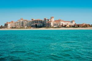 a view of a city from the water at The St. Regis Saadiyat Island Resort, Abu Dhabi in Abu Dhabi