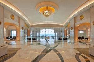 a large lobby with a chandelier and a large hall at The St. Regis Saadiyat Island Resort, Abu Dhabi in Abu Dhabi