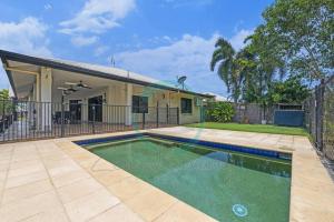 a swimming pool in front of a house at Zenhouse (Bayview) 4BR Luxury Family Home Pool/BBQ in Stuart Park