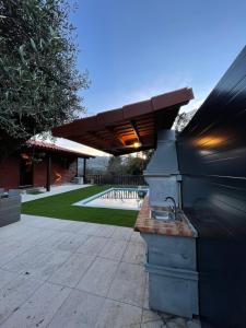 an outdoor grill in a yard with a building at Perfect Mountain Lodge with Pool in Fafião