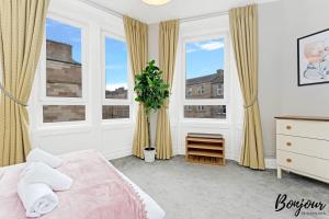 a bedroom with a bed and two windows at Mabillon Suite - Gorgeous-Haymarket, City Centre-FREE Parking by Bonjour Residences Edinburgh in Edinburgh