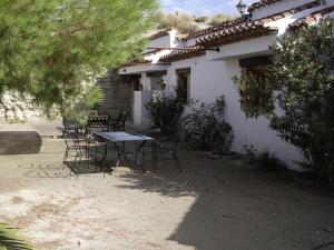 a table and chairs in front of a house at Cuevas Rio Baza in Baza