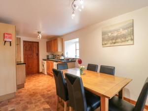 a kitchen and dining room with a wooden table and chairs at The Old Dairy in Bridport