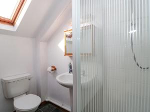a bathroom with a shower and a toilet and a sink at The Old Dairy in Bridport +20 photos
