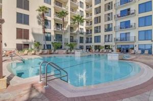 a large swimming pool in front of a large apartment building at Origin at Seahaven in Panama City Beach