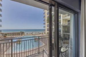 a balcony with a view of the beach and the ocean at Origin at Seahaven in Panama City Beach