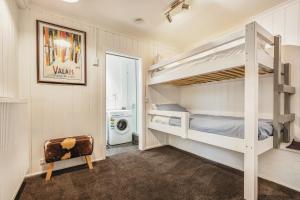a bedroom with two bunk beds and a washing machine at FOUNTAINS 3, Mount Hotham in Mount Hotham