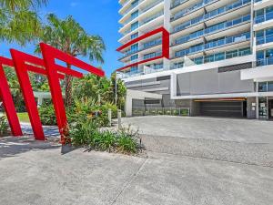a red sculpture in front of a building at Harbour Quays Apartments in Gold Coast