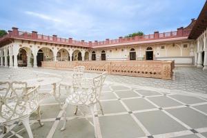 a patio with tables and chairs in a courtyard at Khas Bagh in Jaipur