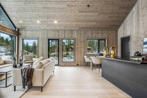 a living room with a couch and a table at Brand new cabin at Hovden cross-country skiing in Hovden