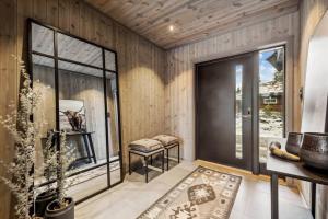 a room with a balcony with a table and a window at Brand new cabin at Hovden cross-country skiing in Hovden