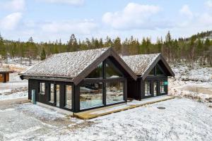 a house in the snow with a roof at Brand new cabin at Hovden cross-country skiing in Hovden